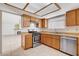 This kitchen is equipped with stainless steel appliances, light wood cabinets, and tile flooring at 8233 Willeta Ave, Las Vegas, NV 89145