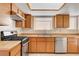 The kitchen features modern stainless steel appliances, ample cabinetry and tile floors at 8233 Willeta Ave, Las Vegas, NV 89145