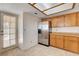 A kitchen featuring stainless steel appliances, tile floors, and a door to the backyard at 8233 Willeta Ave, Las Vegas, NV 89145