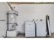 Laundry area includes white washer, dryer and a hot water tank on a platform at 8233 Willeta Ave, Las Vegas, NV 89145