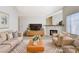 This living room features a fireplace, modern furniture, area rug, and bright natural light at 8233 Willeta Ave, Las Vegas, NV 89145