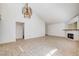 Open-concept living room featuring tile flooring, vaulted ceiling and neutral paint at 8233 Willeta Ave, Las Vegas, NV 89145