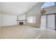 Spacious living room featuring tile flooring, vaulted ceiling and sliding glass door at 8233 Willeta Ave, Las Vegas, NV 89145