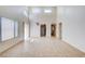 Open-concept living room with high ceilings, tile flooring, and large windows offering lots of light at 8233 Willeta Ave, Las Vegas, NV 89145