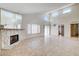 Spacious living room with vaulted ceiling, decorative fireplace and tile flooring at 8233 Willeta Ave, Las Vegas, NV 89145
