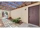 Private gated patio with a covered pergola and mature landscaping at 8233 Willeta Ave, Las Vegas, NV 89145