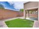 The backyard features a small grassy area, low-maintenance gravel, and a covered patio at 8745 Dodds Canyon St, Las Vegas, NV 89131