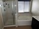 Bathroom featuring a shower, a tub with jets, marble countertop, and window with blinds at 8745 Dodds Canyon St, Las Vegas, NV 89131