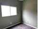 Bedroom with gray walls, carpet flooring, and a window at 8745 Dodds Canyon St, Las Vegas, NV 89131