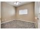 This bedroom features carpet, a ceiling fan, and a window with blinds at 8745 Dodds Canyon St, Las Vegas, NV 89131
