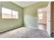 Carpeted bedroom with a view of the neighborhood from the window and an ensuite bathroom at 8745 Dodds Canyon St, Las Vegas, NV 89131