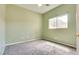 Cozy carpeted bedroom with a ceiling fan and a window letting in natural light at 8745 Dodds Canyon St, Las Vegas, NV 89131