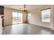 Cozy dining area with sliding glass doors leading to a balcony and wood-look floors at 8745 Dodds Canyon St, Las Vegas, NV 89131