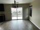 Bright dining area features sliding glass doors to patio and modern chandelier above a dark wood-look floor at 8745 Dodds Canyon St, Las Vegas, NV 89131