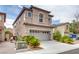 Two-story stucco home with a two-car garage, desert landscaping, and a concrete driveway at 8745 Dodds Canyon St, Las Vegas, NV 89131