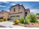 Two-story stucco home with a two-car garage, desert landscaping, and a concrete driveway at 8745 Dodds Canyon St, Las Vegas, NV 89131