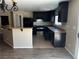 Modern kitchen features dark wood cabinets, stainless steel appliances, tan countertops and tiled floors at 8745 Dodds Canyon St, Las Vegas, NV 89131