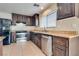 Well-equipped kitchen with stainless steel appliances and dark wood cabinets at 8745 Dodds Canyon St, Las Vegas, NV 89131