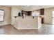 Spacious kitchen island with bar seating and wood-look floors at 8745 Dodds Canyon St, Las Vegas, NV 89131