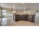 Kitchen island with bar seating and granite countertops at 8745 Dodds Canyon St, Las Vegas, NV 89131