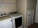 The laundry room includes a washer, dryer, and shelving at 8745 Dodds Canyon St, Las Vegas, NV 89131