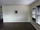 Bright living room features dark wood-look flooring and ample natural light from large windows at 8745 Dodds Canyon St, Las Vegas, NV 89131