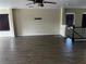 Spacious living room features dark wood-look flooring and ample natural light from large windows at 8745 Dodds Canyon St, Las Vegas, NV 89131