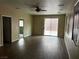 Spacious living room featuring wood floors, a ceiling fan, and access to the backyard at 8745 Dodds Canyon St, Las Vegas, NV 89131