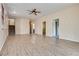 Open floor plan with laminate floors, neutral paint, and a staircase leading to the upper level at 8745 Dodds Canyon St, Las Vegas, NV 89131