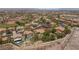 Aerial view showing the real estate property with a private pool and lush landscaping at 900 Cantura Mills Rd, Henderson, NV 89052