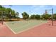Outdoor basketball court featuring multiple hoops and mature trees at 900 Cantura Mills Rd, Henderson, NV 89052
