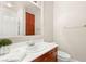 Bathroom with sink, mirror, storage cabinet and toilet at 900 Cantura Mills Rd, Henderson, NV 89052