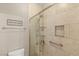 Bathroom featuring tile shower with glass door, tile walls and 'love you more' sign at 900 Cantura Mills Rd, Henderson, NV 89052