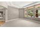 Bright bedroom with large windows overlooking the backyard pool and lush landscaping at 900 Cantura Mills Rd, Henderson, NV 89052