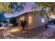 Exterior view of a home with stone pathway leading to a private backyard with a pool at 900 Cantura Mills Rd, Henderson, NV 89052