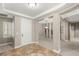Inviting foyer with tiled floor, neutral walls, white door, and views into a dining room at 900 Cantura Mills Rd, Henderson, NV 89052