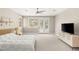 Spacious main bedroom featuring neutral tones, plush carpeting, a ceiling fan, and large windows with shutter blinds at 900 Cantura Mills Rd, Henderson, NV 89052