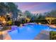 Beautiful pool with spa, rock wall, and privacy landscaping at 900 Cantura Mills Rd, Henderson, NV 89052
