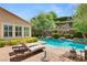 Inviting pool and spa area with lounge chairs and mature landscaping at 900 Cantura Mills Rd, Henderson, NV 89052