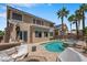 A backyard with a pool, spa, covered patio, and lush landscaping for entertaining or relaxing at 9017 Cotton Rose Way, Las Vegas, NV 89134