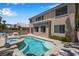 Two story home with a backyard pool, integrated jacuzzi, mature trees, and brick patio at 9017 Cotton Rose Way, Las Vegas, NV 89134