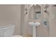Powder room featuring pedestal sink, ornate mirror and matching sconces at 9017 Cotton Rose Way, Las Vegas, NV 89134
