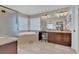 Spacious bathroom with glass-enclosed shower, soaking tub, vanity with granite countertop and double sinks at 9017 Cotton Rose Way, Las Vegas, NV 89134