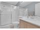Bright bathroom with a sliding glass shower door, toilet and sink vanity at 9017 Cotton Rose Way, Las Vegas, NV 89134
