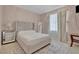 Neutral bedroom with curtains, a mirror and a tufted headboard at 9017 Cotton Rose Way, Las Vegas, NV 89134