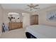 Beige bedroom featuring a bed, ceiling fan, an arched mirror and drawers at 9017 Cotton Rose Way, Las Vegas, NV 89134