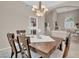 Dining room with dark wood table set under elegant chandelier; open to living space at 9017 Cotton Rose Way, Las Vegas, NV 89134