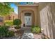 Inviting front entrance with double doors, manicured bushes and covered porch at 9017 Cotton Rose Way, Las Vegas, NV 89134