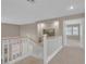 Upstairs hallway with neutral carpet and white railings at 9017 Cotton Rose Way, Las Vegas, NV 89134