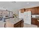 Open-concept kitchen that flows into the cozy living room with fireplace at 9017 Cotton Rose Way, Las Vegas, NV 89134